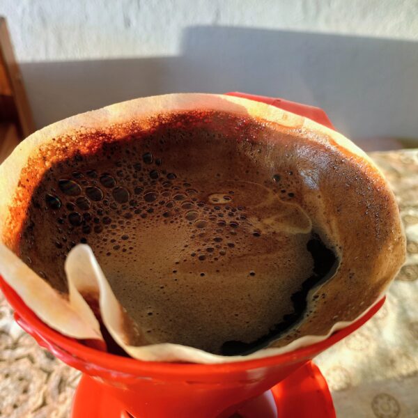 Ground coffee bag hero image in warm earthy tones for Flicker Bean Coffee